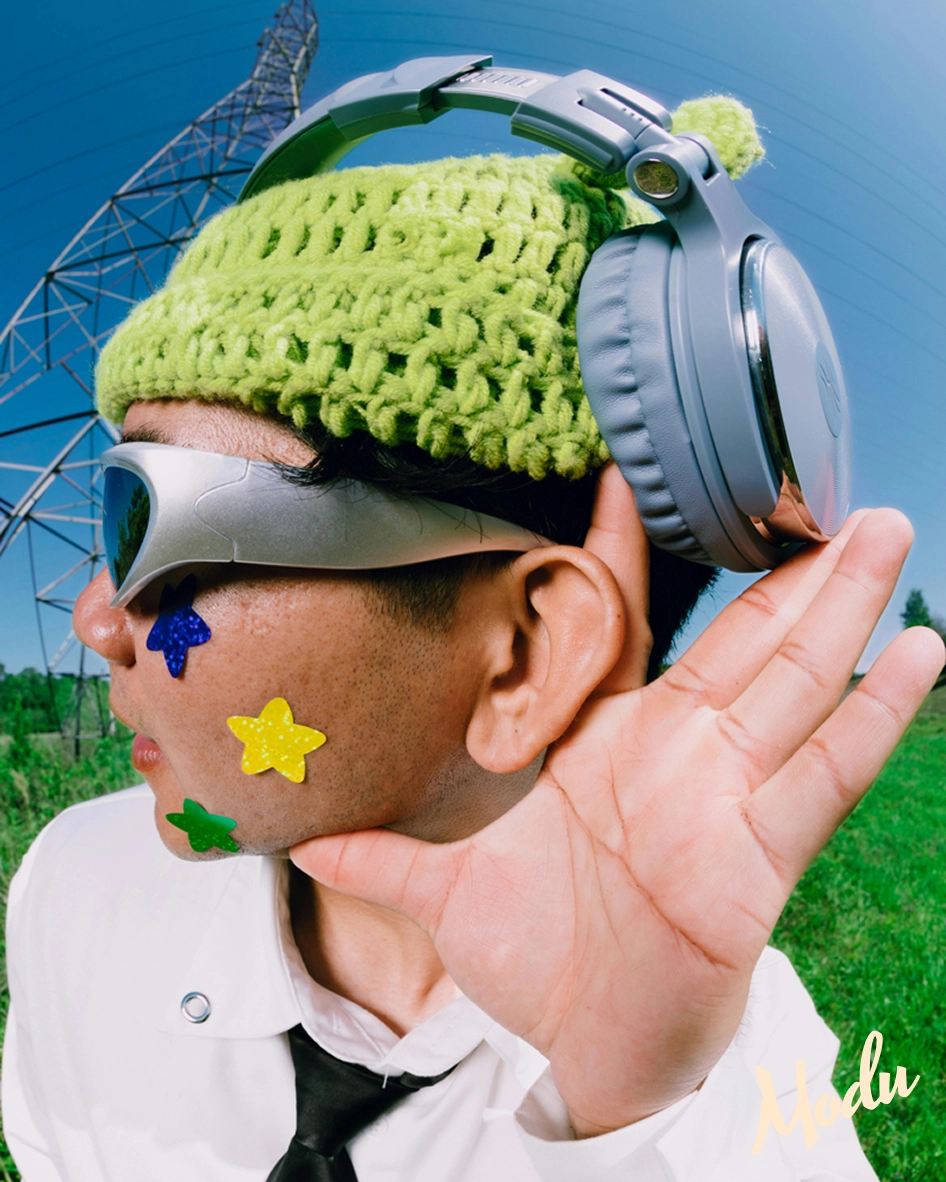 Man turned to the side with headphones making listening motion